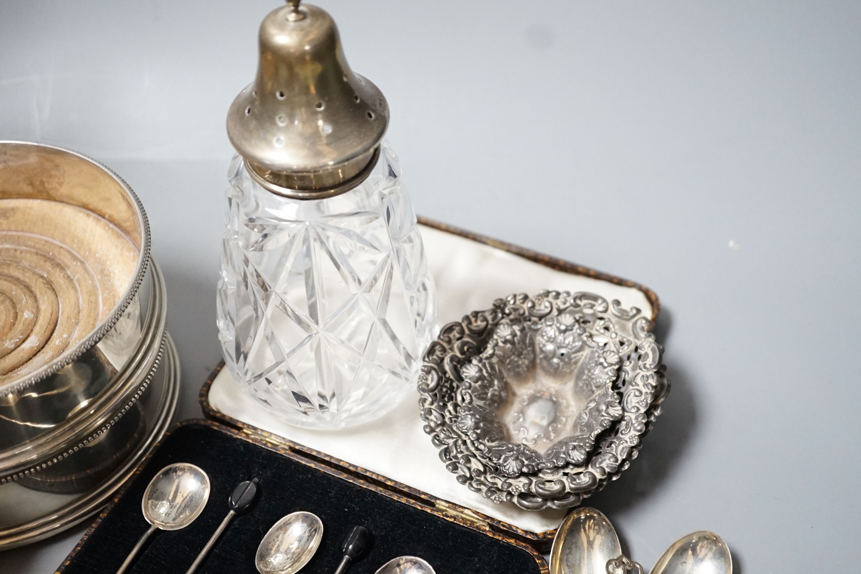 Mixed small silver including a pair of modern silver mounted wine coasters, 12.6cm, two silver mounted photograph frames, silver dish by William Comyns, three silver bonbon dishes, two sets of six silver teaspoons, a sil